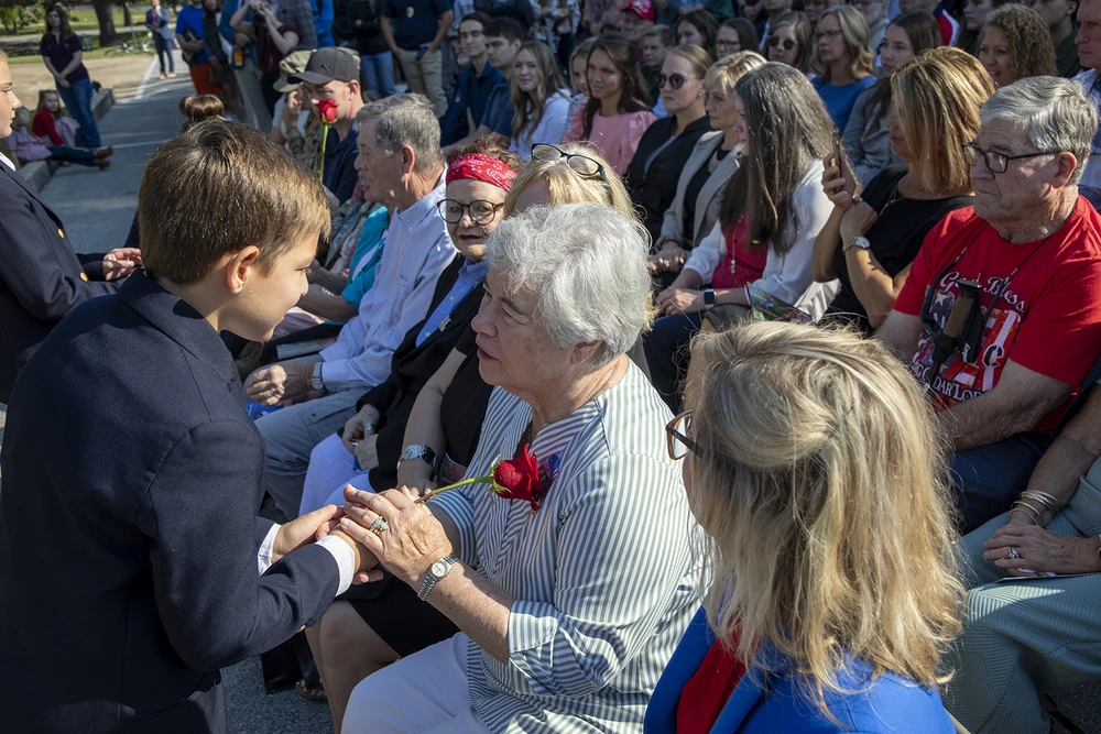 Students handing out roses